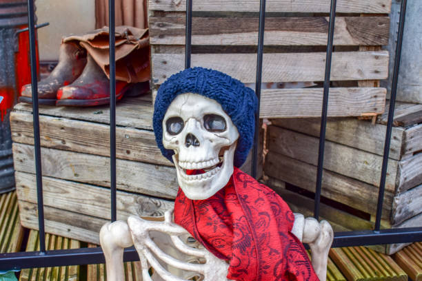 Skeleton in beanie and scarf at haunted house display, Clapham Common, UK