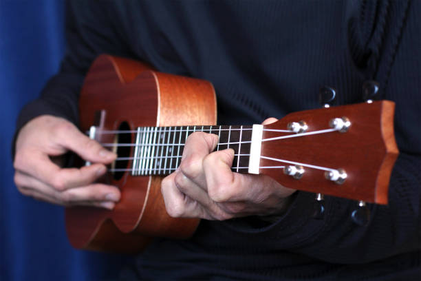 istock musician plays on ukulele, small depth of field 930054566