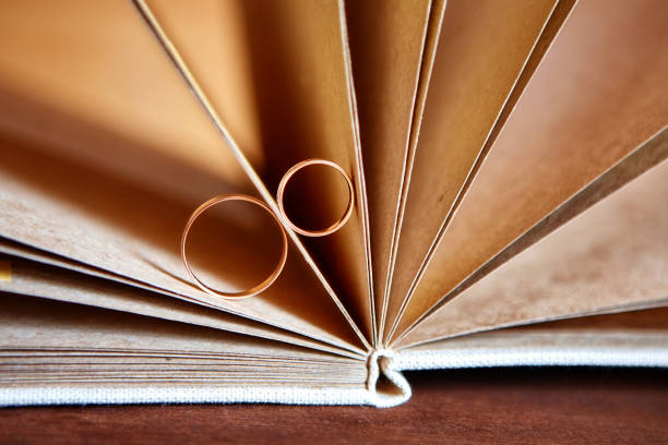 istock Gold wedding rings in a book made by hand from natural materials 930058744