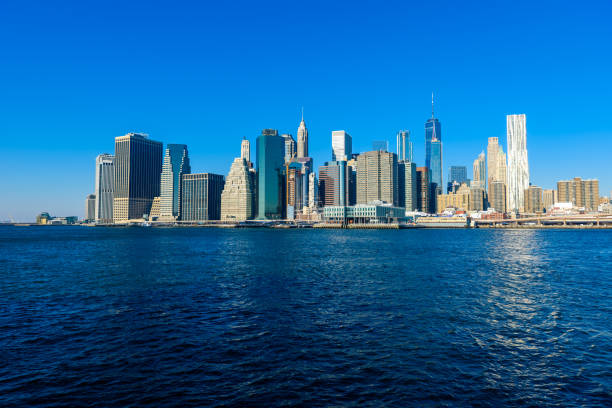 istock Brooklyn Bridge and the Lower Manhattan skyline panorama from Brooklyn Bridge Park riverbank, New York City, USA 930062986
