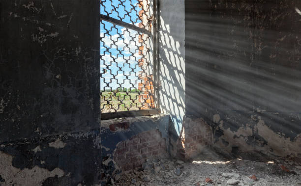 istock Sunlight passing through a window through the iron grate in an abandoned room 930063884
