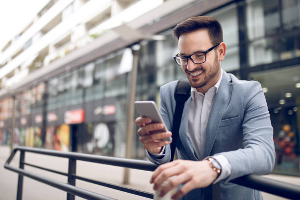 istock Smiling businessman reading text message on mobile phone 930067954