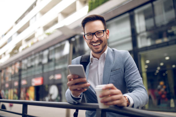 istock Smiling businessman reading text message on mobile phone 930071014