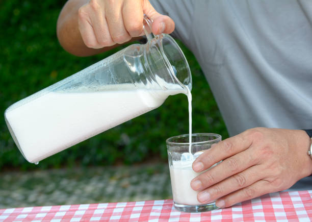istock Hand on pour milk to glass 930075758