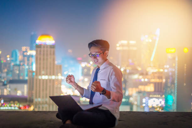istock Business using laptop and digital tablet at skyscaper background 930083740