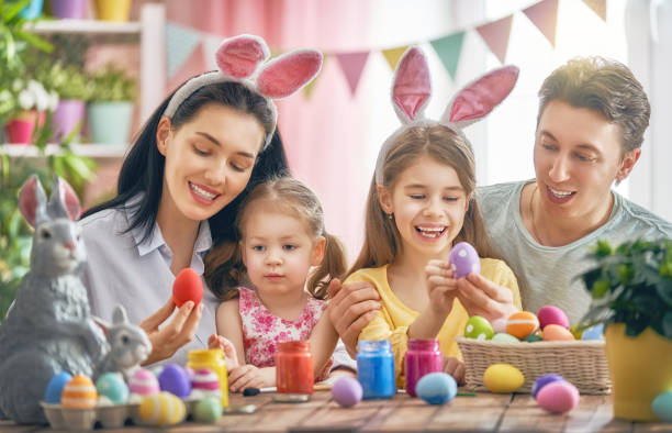 istock family are painting eggs 930087076