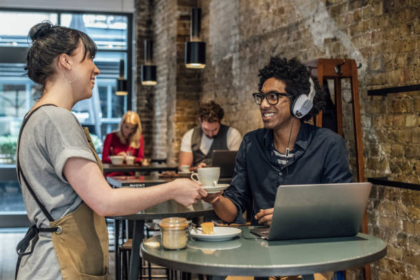 istock Waitress serving man coffee in cafe and smiling 930090008