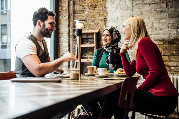 istock Group of friends chatting in coffee shop 930090014