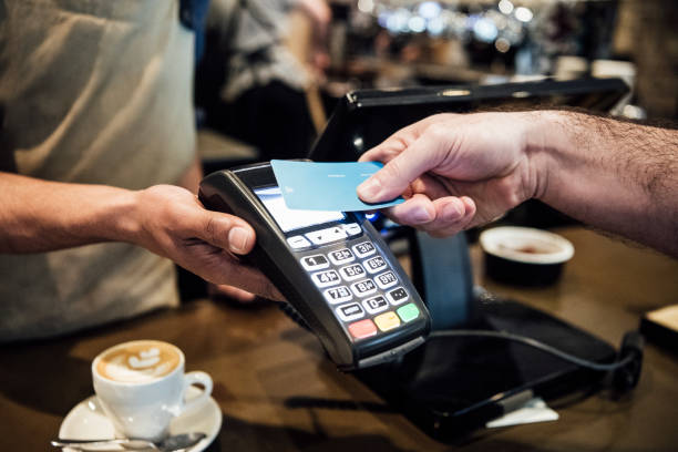 istock Man paying on card machine in cafe close up 930090032