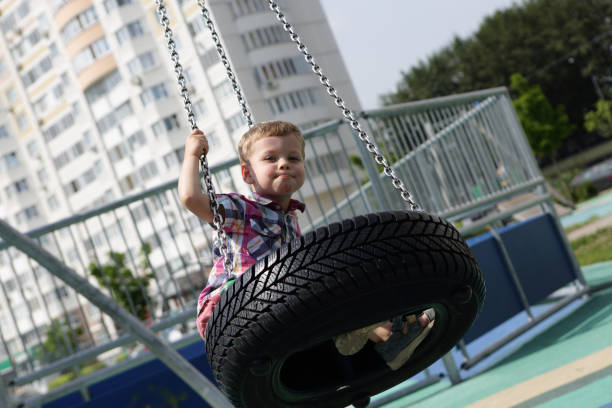 istock Child on swing out of tire 930090730