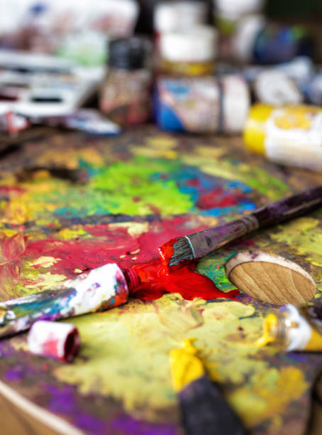 istock Brushes on palette of colorful paint 930090818