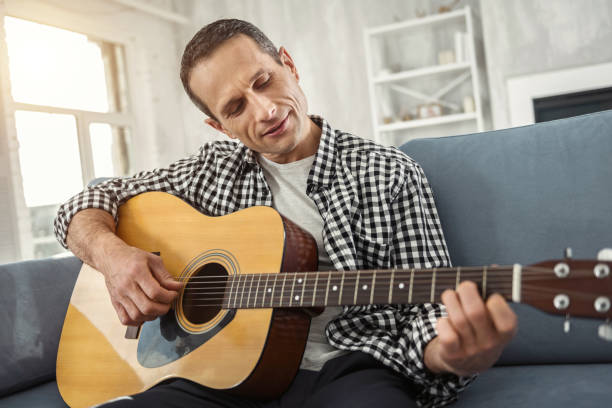 istock Inspired man relaxing and playing the guitar 930090826