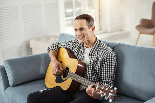 istock Exuberant man relaxing and playing the guitar 930091024