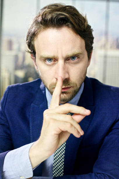 istock Cool handsome business man silence sign in office 930091358