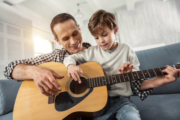 istock Inspired boy learning to play the guitar 930091550