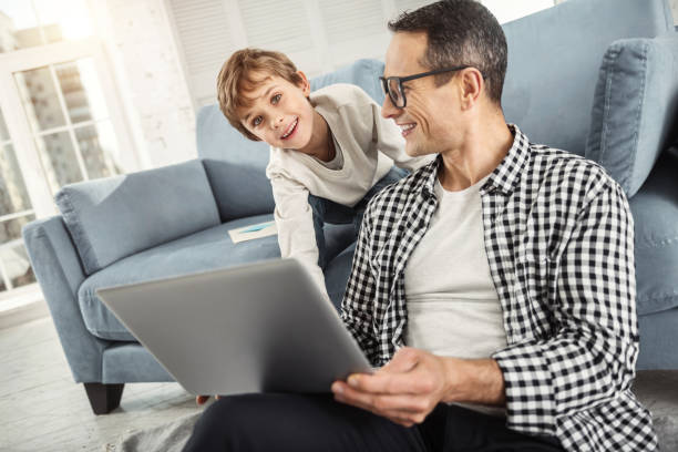 istock Happy son sitting behind his father 930094232