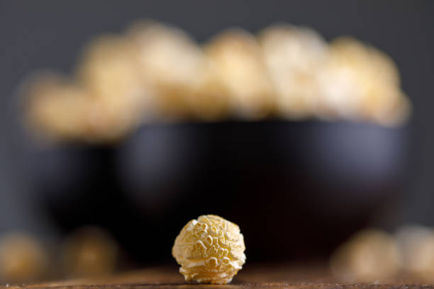 istock Popcorn macro. A bowl of popcorn in the background. 930103014