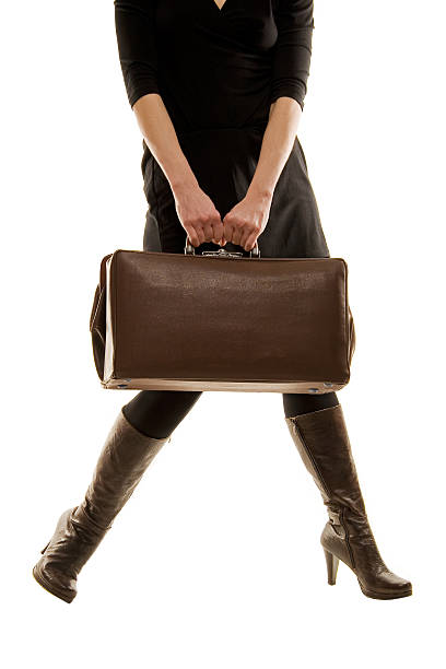 brown leather old vintage luggage bag/briefcase hold by a woman stock photo