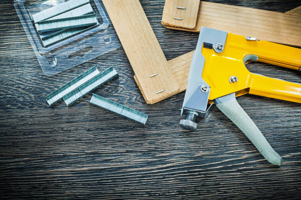 istock Construction stapler staples wooden planks top view 930121380