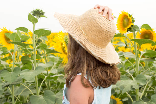 istock young girl in sunflower field 930125554