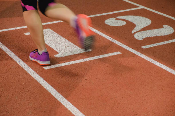 In the stadium with blurred motion feet of runner.