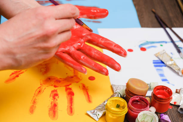 istock Artist paint brushes on wooden background, craft art process 930126394