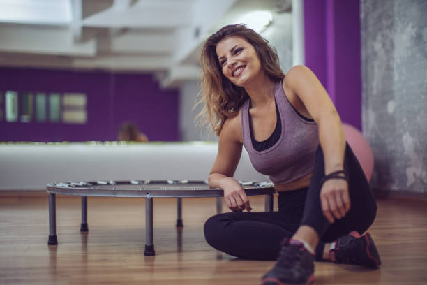 istock Woman sitting on gym floor 930140938