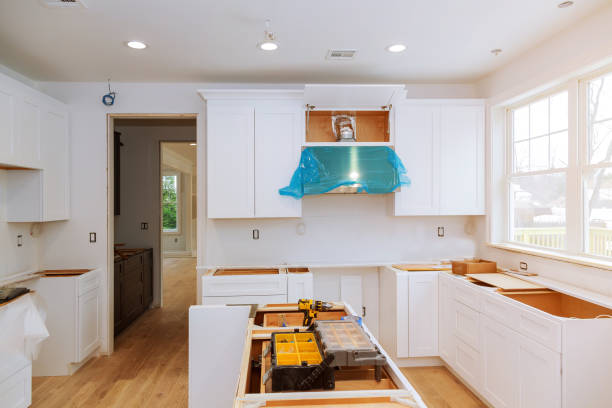 istock Custom kitchen cabinets in various stages of installation base for island in center 930143838