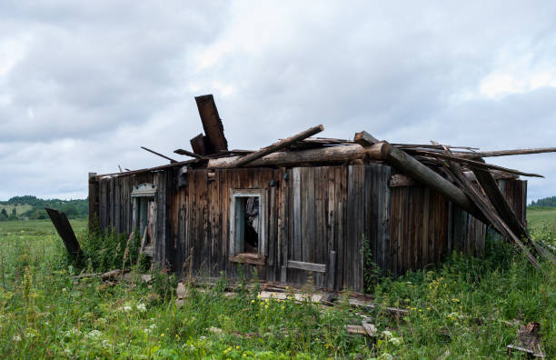 istock Close-up an old ruined wooden house. 930144234