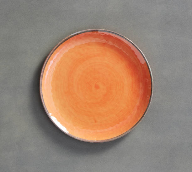 istock Orange Swirl Melamine Plate with dark gray background 930147940