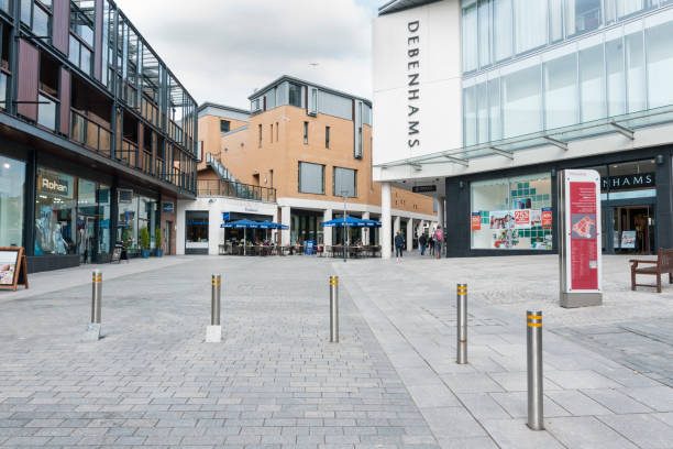Exeter Princesshay town centre in Devon UK Showing Debenhams, shops and cafe with people sitting outside and other shoppers devon photos stock pictures, royalty-free photos & images
