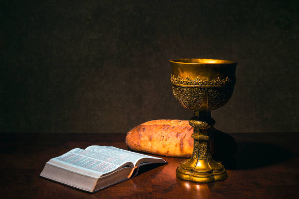 istock Goblet with wine bread and Holy Bible on a table 930151844