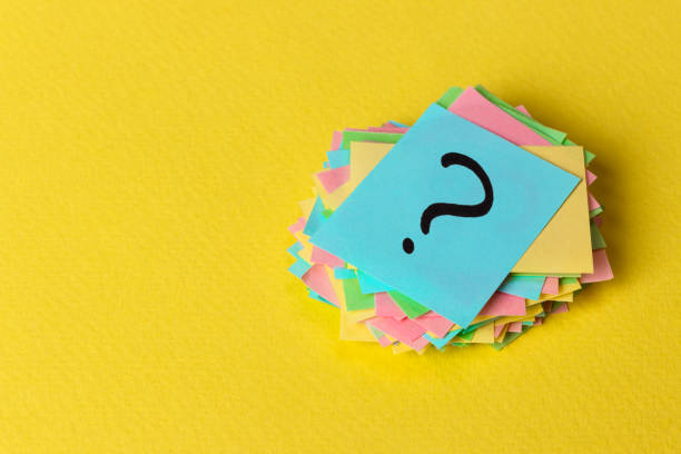 istock Question mark paper heap on yellow background, concept for confusion 930155056