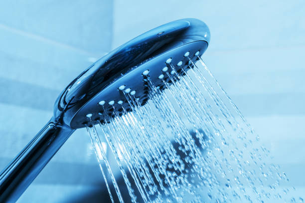 istock Shower head and splashing water closeup 930155878