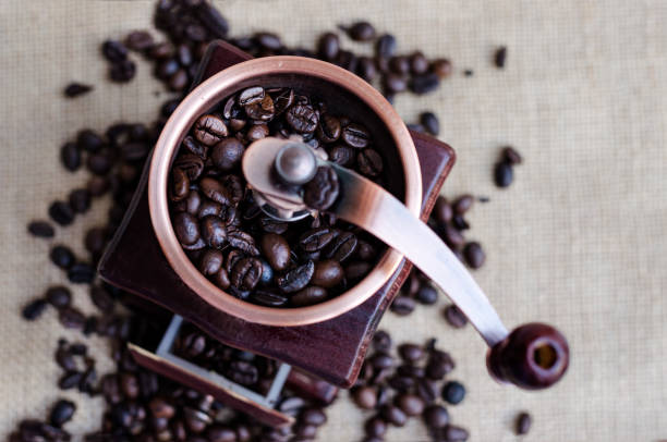 istock wooden coffee grinder and coffee beans background 930156616