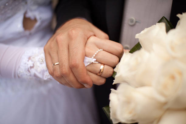 istock Loving hands of a bride and bridegroom 930157754