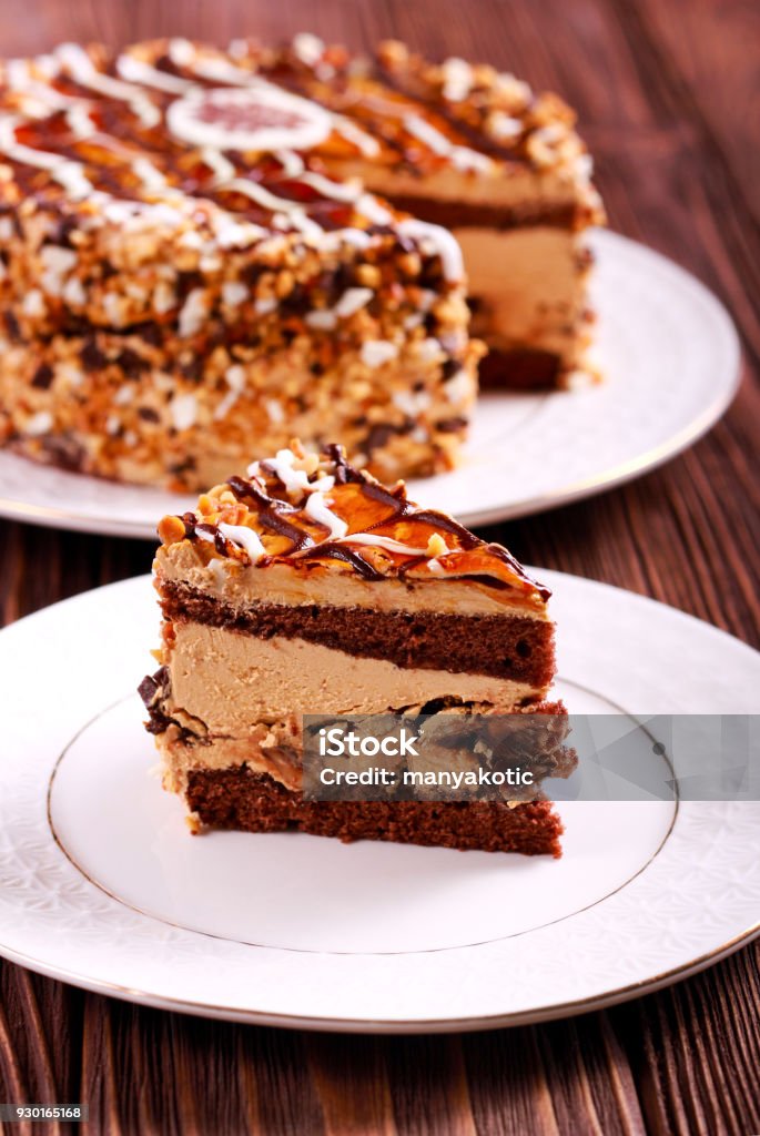 Caramel and nut layered cake, sliced Caramel and nut layered cake, sliced on plate Baking Stock Photo