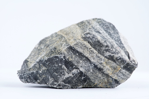Sample of granite rock isolated on white.