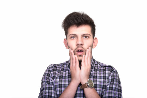 istock Portrait of surprised young man looking at camera over white background 930172698