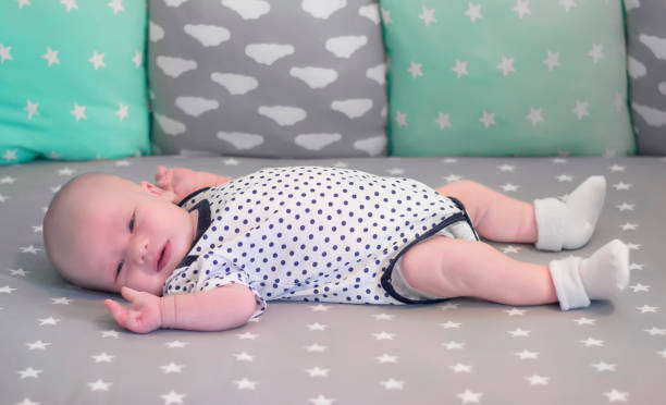istock Newborn baby lying on the bed on her back 930182360