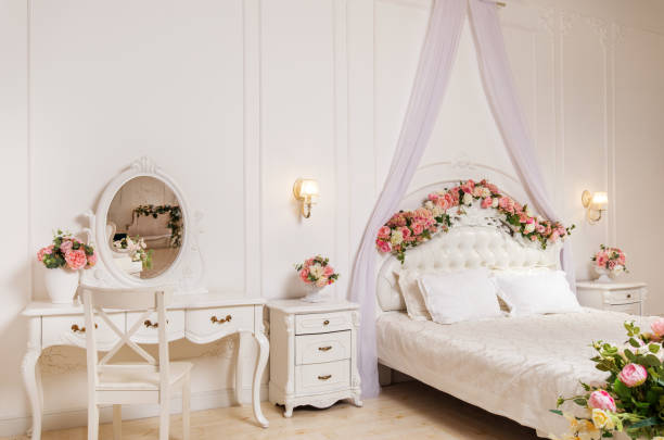 High angle view of happy newlyweds holding hands and talking to each other in the bedroom.