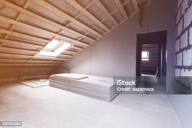 Interior Of Room Apartment And Materials Pieces Of Drywall During On The Renovation And Construction Remodeling And Repairing Wall From Gypsum Plasterboard Or Drywall And Inside Roof Warming Stock Photo - Download Image Now