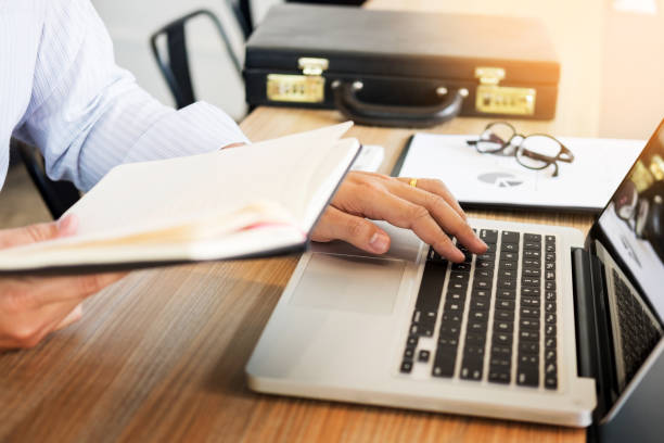 istock Cropped Hand Of Businessman Working At Table 930205442