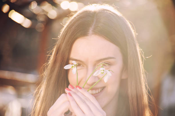 istock Beautiful girl holding snowdrops 930213530