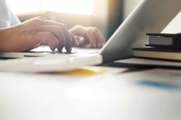 istock Cropped Hands Of Businessman Using Laptop At Table 930215934