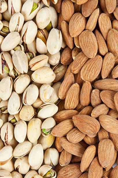 almonds and pistachios background stock photo