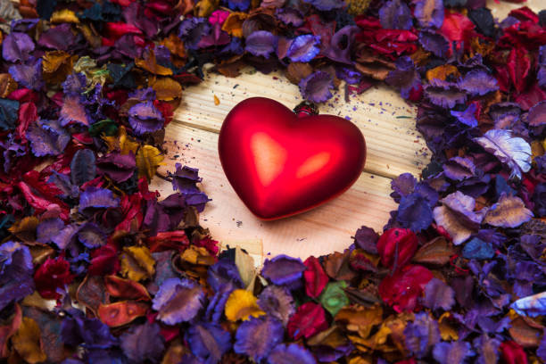 istock High Angle View Of Red Heart Shape With Colorful Petals On Table 930234214
