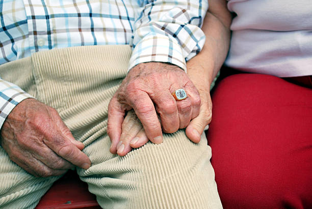 istock senior couple holding hands 93023969