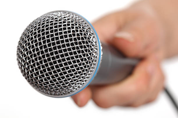 istock Close-up of a microphone being held by a blurred hand 93023990
