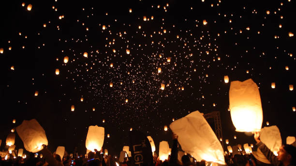 istock Crowd Releasing Illuminated Paper Lanterns At Night 930241760